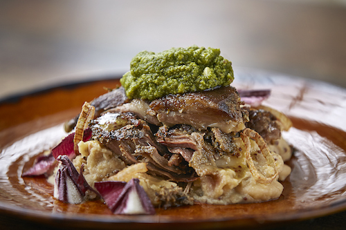 Slow roasted lamb shoulder on butter bean purée with pesto